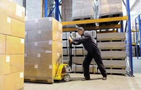 Worker carrying heavy equipments | Vitran Express Worker carrying heavy equipments | Vitran Express